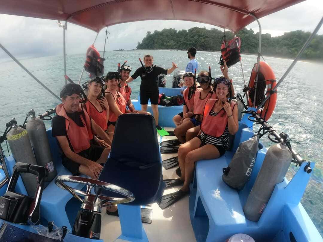Guests on a May One Drake Bay boat, ready to jump in for snorkeling off Caño Island, Costa Rica.